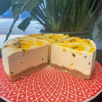 A sliced cheesecake on a patterned plate