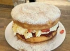 Layered celebration cake topped with a light dusting of icing sugar