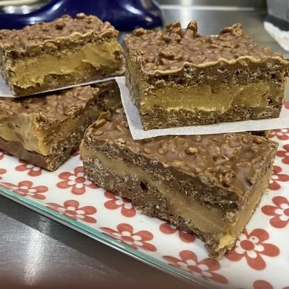 Chocolate and caramel dessert slices arranged on a plate