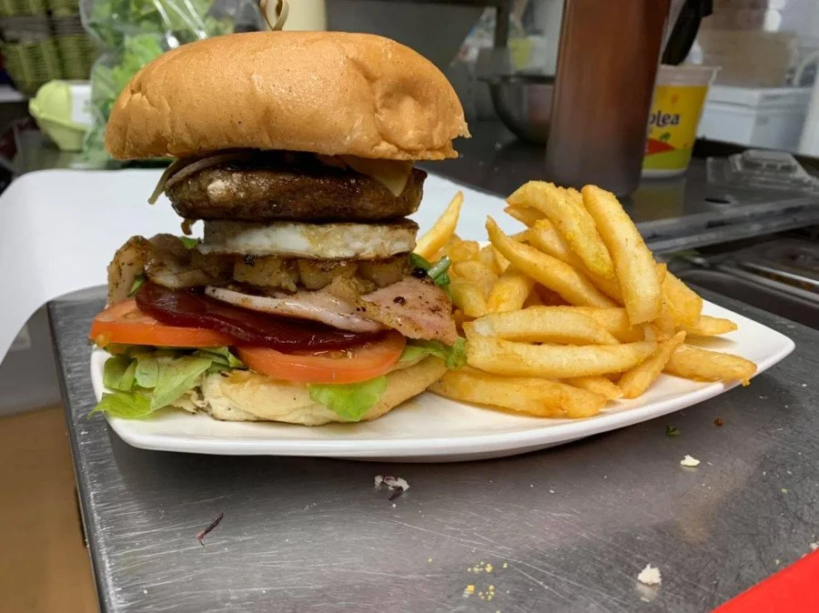 Burger and fries served at Caffin8 Cafe